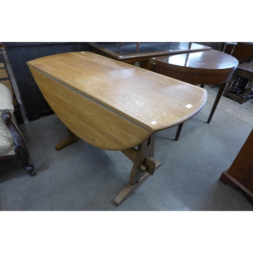 113 - An Ercol style elm drop-leaf table