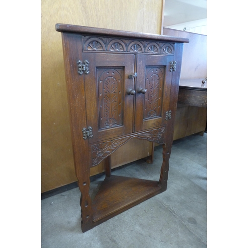 120 - A small carved oak corner cabinet