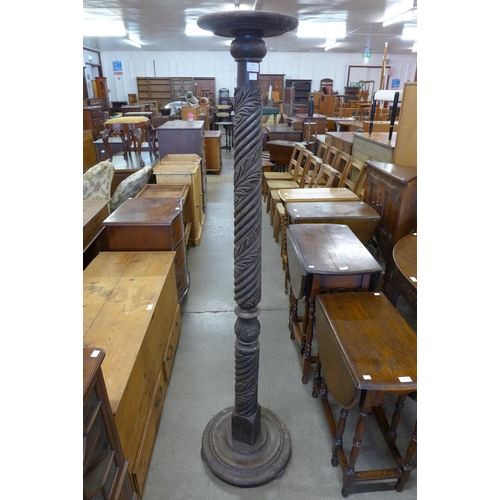 125 - A tall Edward VII Hepplewhite Revival carved mahogany torchere