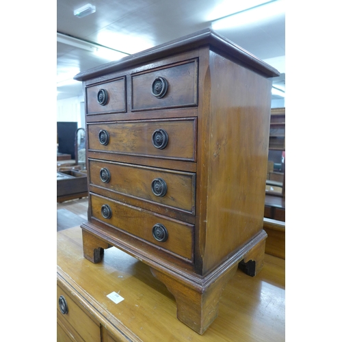 149 - A small walnut chest of drawers