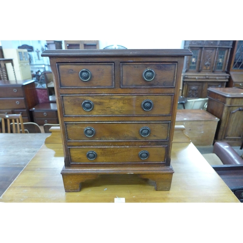 149 - A small walnut chest of drawers