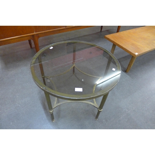 16 - An Italian brass and glass topped circular coffee table