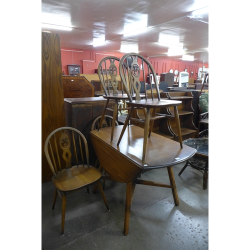 163 - An Ercol Golden Dawn elm and beech drop-leaf table and four chairs