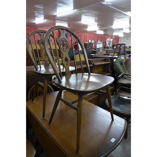 163 - An Ercol Golden Dawn elm and beech drop-leaf table and four chairs