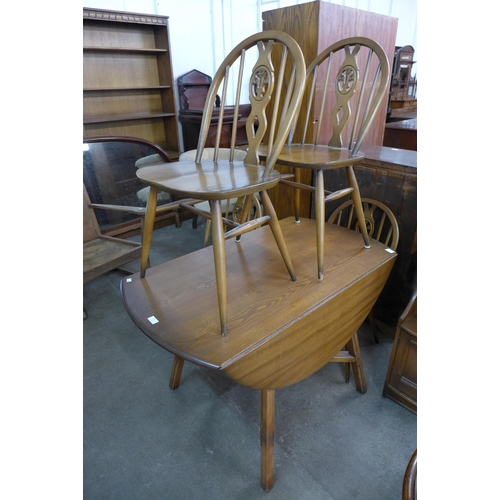 163 - An Ercol Golden Dawn elm and beech drop-leaf table and four chairs