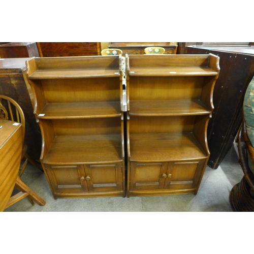 164 - A pair of Ercol Golden Dawn ash waterfall front open bookcases