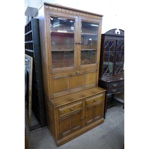 166 - An Ercol Golden Dawn elm bookcase