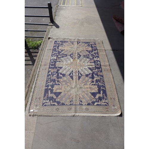 169 - An Eastern hand made blue ground rug