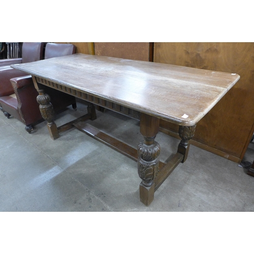 173 - A 17th Century style carved oak refectory table