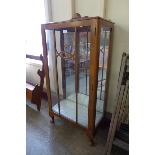 191 - An Art Deco walnut single door display cabinet