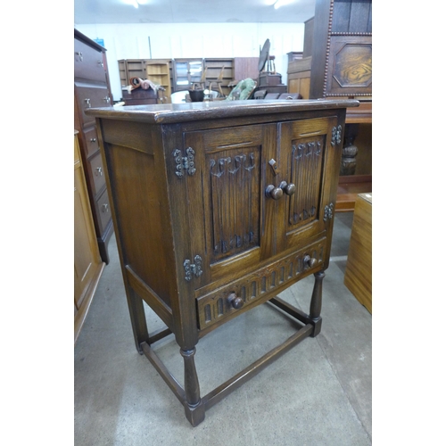 199 - A carved oak linenfold two door credence cupboard