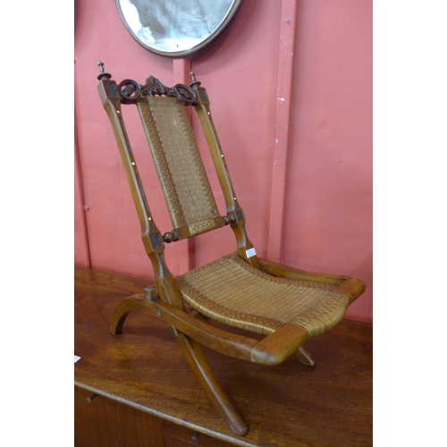 2 - A small Victorian walnut folding campaign chair, the back rest set with ivory cabochons. This lot is... 