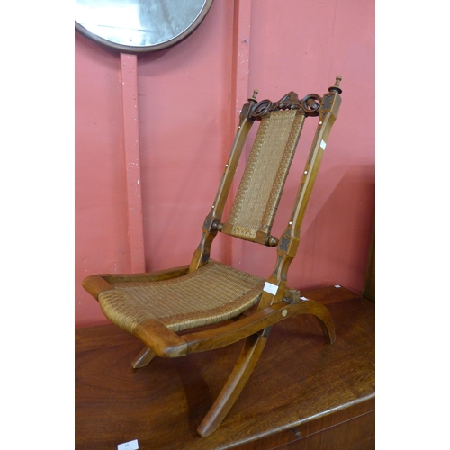 2 - A small Victorian walnut folding campaign chair, the back rest set with ivory cabochons. This lot is... 