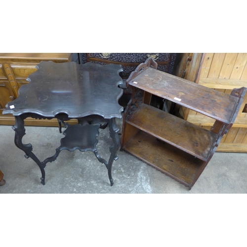 216 - A Victorian carved oak wall hanging bookcase and an Edward VII ebonised occasional table