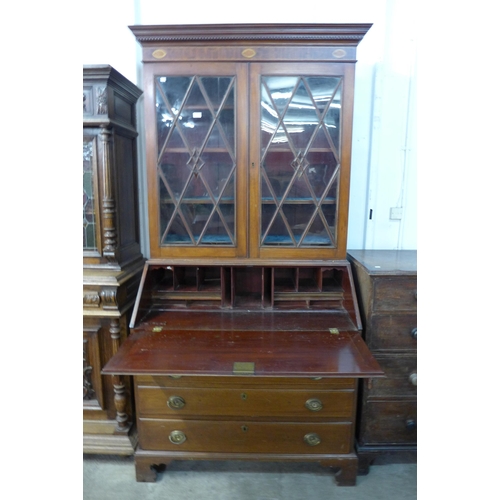 221 - A George III style inlaid mahogany bureau bookcase