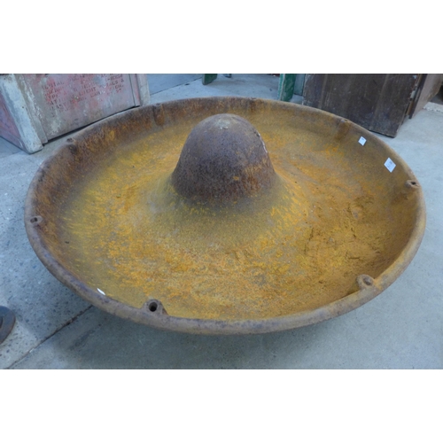 243 - A cast iron Mexican hat shaped pig feeder