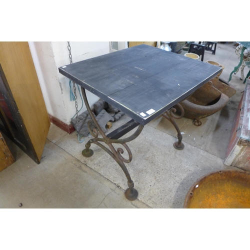 244 - A cast iron garden table, with later associated pine top