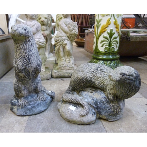 267 - Two concrete garden figures of otters