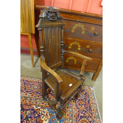 3 - A Victorian Jacobean Revival carved oak elbow chair