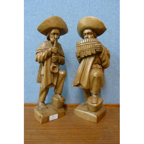 345 - A pair of South American carved wood figures of musicians