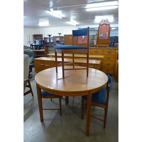 39 - A McIntosh circular teak extending dining table and four chairs