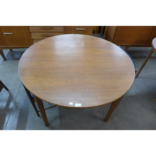 39 - A McIntosh circular teak extending dining table and four chairs