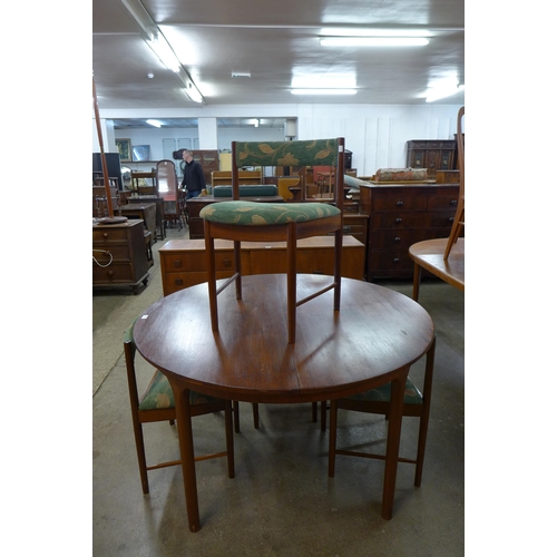 44 - A McIntosh circular teak extending dining table and four chairs