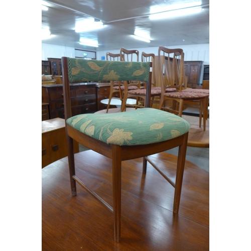 44 - A McIntosh circular teak extending dining table and four chairs