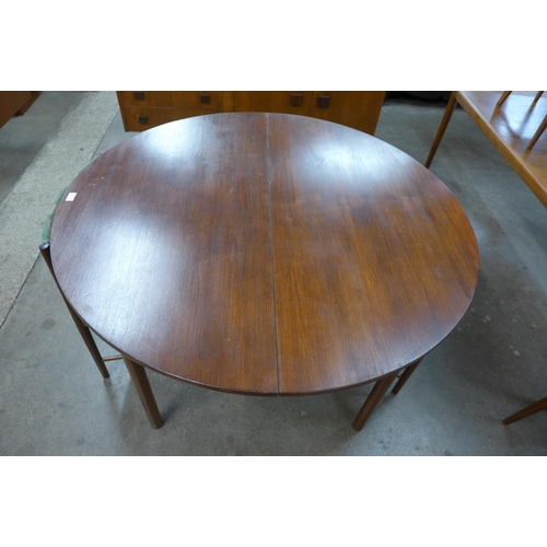 44 - A McIntosh circular teak extending dining table and four chairs