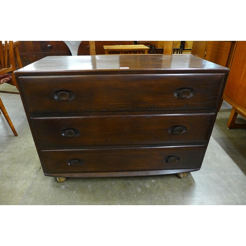 52 - An Ercol dark elm Wndsor chest of drawers