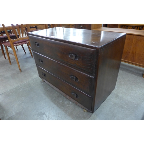 52 - An Ercol dark elm Wndsor chest of drawers