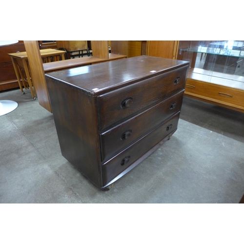 52 - An Ercol dark elm Wndsor chest of drawers