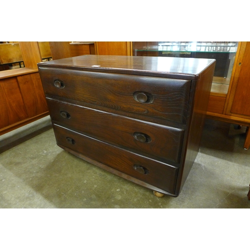 52 - An Ercol dark elm Wndsor chest of drawers