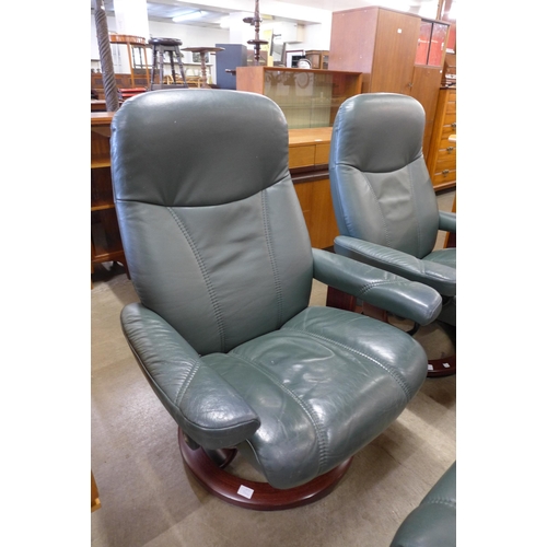 74 - A pair of Norwegian Ekorness Stressless beech and green leather revolving lounge chairs and matching... 