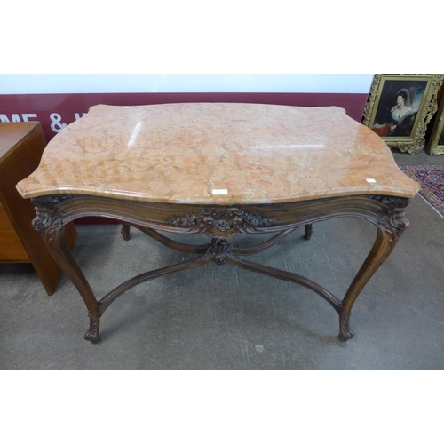 9 - A French Louis XV style carved walnut and marble topped serpentine centre table