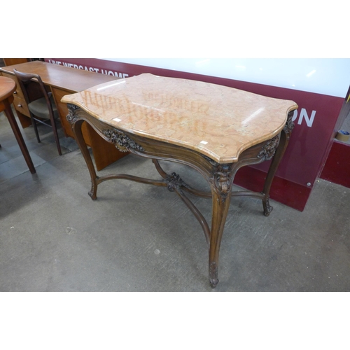 9 - A French Louis XV style carved walnut and marble topped serpentine centre table