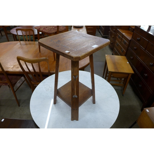 98 - An Arts and Crafts inlaid oak occasional table