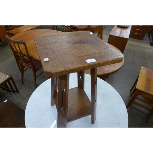 98 - An Arts and Crafts inlaid oak occasional table