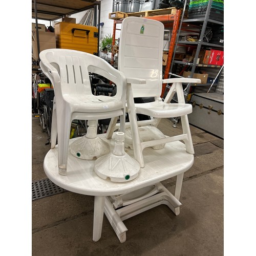 2155 - White plastic garden furniture comprising of a table, three parasol bases and 6 chairs