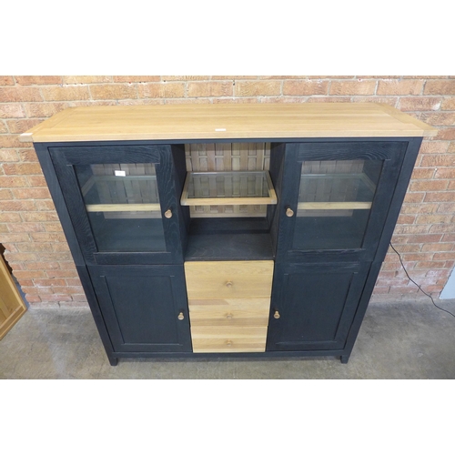 14 - A black painted and oak hutch cabinet (H=143cm x W=150cm x D=45cm)