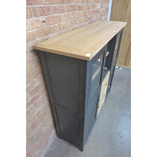 14 - A black painted and oak hutch cabinet (H=143cm x W=150cm x D=45cm)