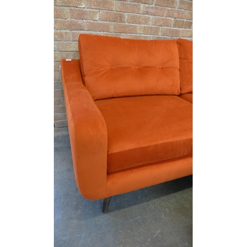 20 - A tangerine velvet buttoned back three seater sofa and footstool (H=90cm x W=187cm x D=90cm)