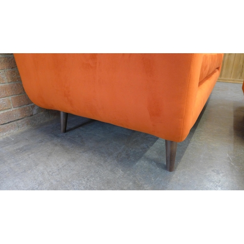 20 - A tangerine velvet buttoned back three seater sofa and footstool (H=90cm x W=187cm x D=90cm)