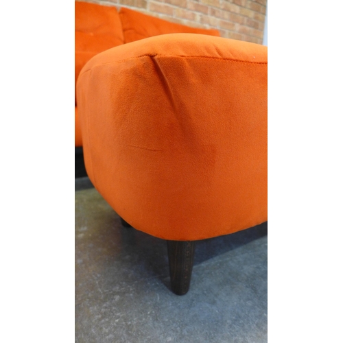 20 - A tangerine velvet buttoned back three seater sofa and footstool (H=90cm x W=187cm x D=90cm)