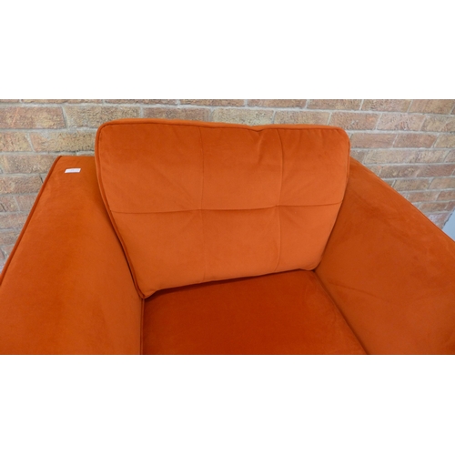 21 - A tangerine velvet pinched back armchair (H=90cm x W=103cm x D=96cm)