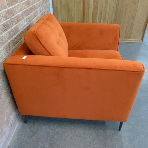 21 - A tangerine velvet pinched back armchair (H=90cm x W=103cm x D=96cm)