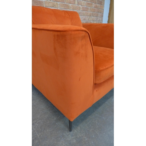 21 - A tangerine velvet pinched back armchair (H=90cm x W=103cm x D=96cm)