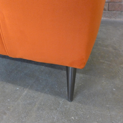 21 - A tangerine velvet pinched back armchair (H=90cm x W=103cm x D=96cm)