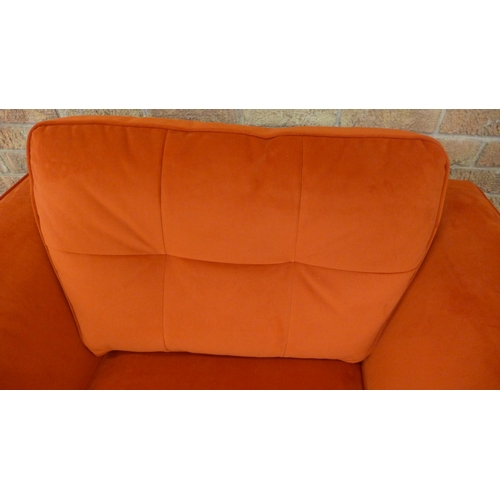 21 - A tangerine velvet pinched back armchair (H=90cm x W=103cm x D=96cm)