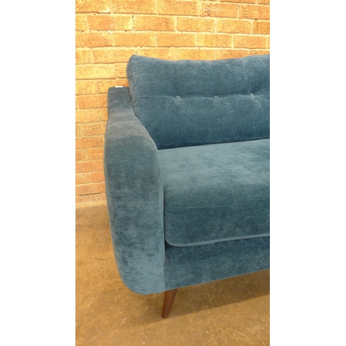 22 - A teal velvet buttoned back three seater sofa, small tear (H=90cm x W=190cm x D=90cm)